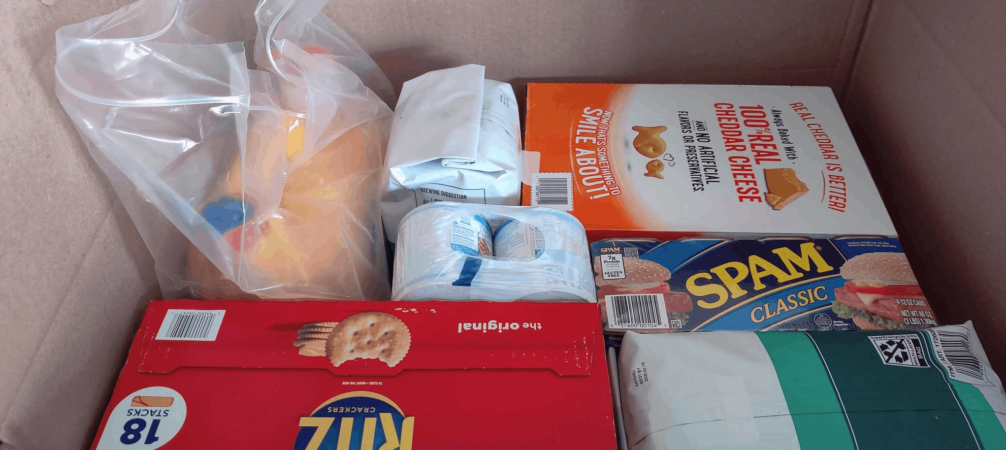 Boxed packed edge to edge with spam, detergent, crackers, coffee and condensed milk