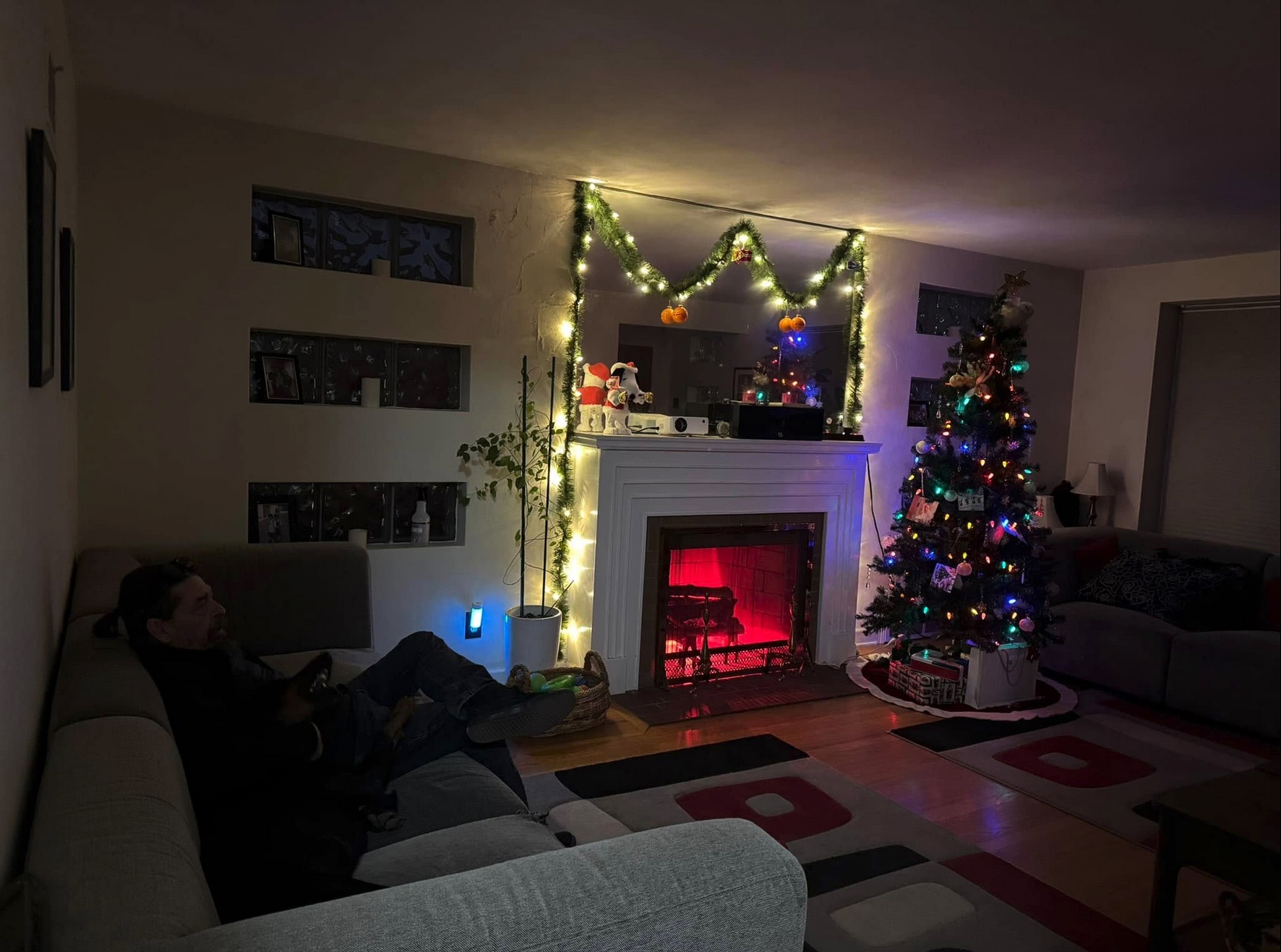 Jeff and Mowgli sitting on the couch looking at the tree