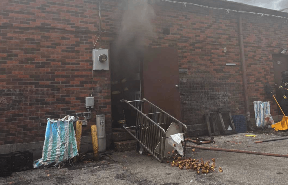 back of old town donuts with smoke and an upturned rack of baked goods